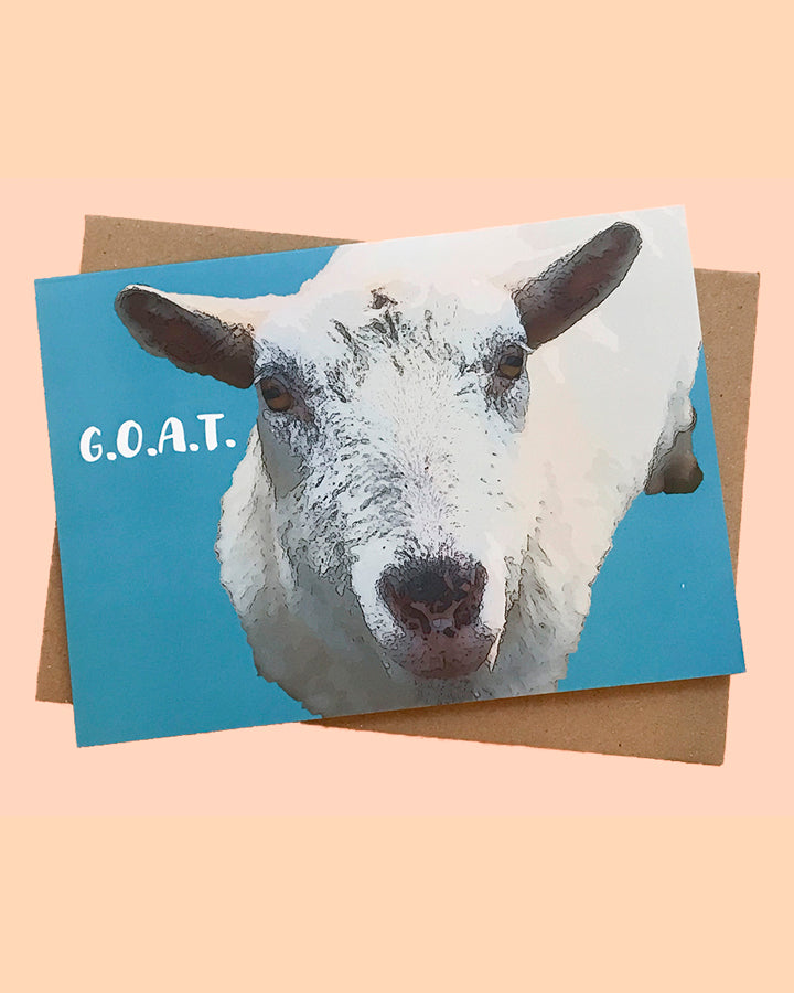 Greeting card of goat  with G.O.A.T. text on turquoise background. From The Flower Moon Fox