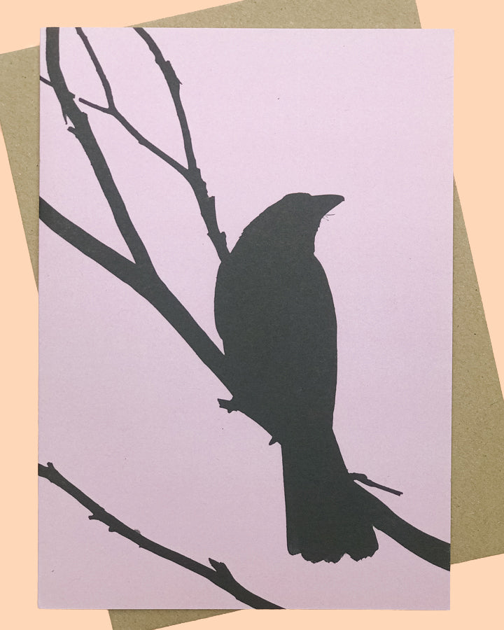 Greeting card wth black illustration of currawong bird on mauve background. From The Flower Moon Fox